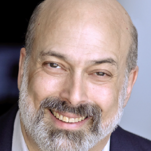 Headshot of Dr. Joel Snyder. He is a smiling man with a gray and white beard and very little hair on top of his head.